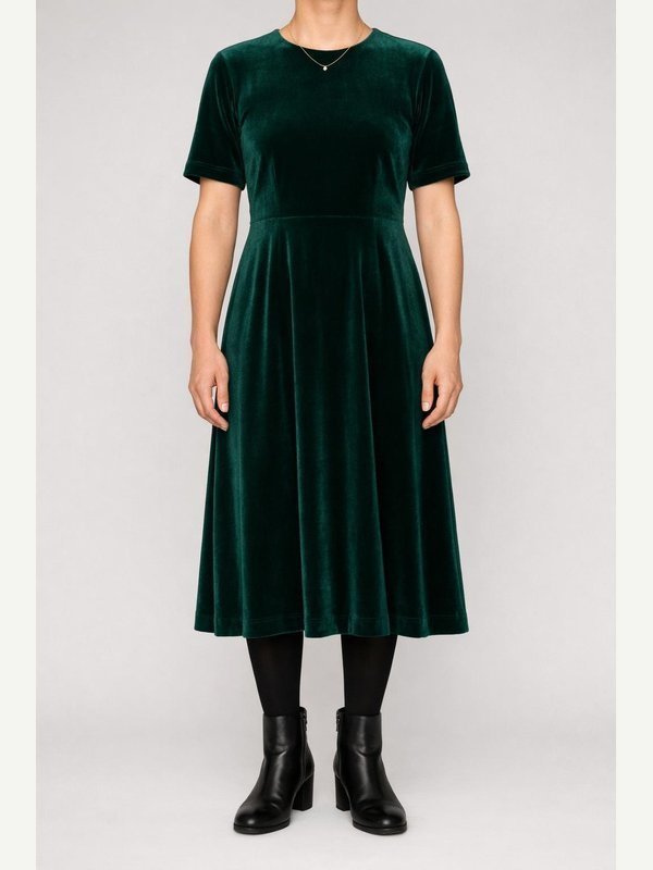 Emerald velvet midi dress, black opaque tights, black ankle boots and a small gold necklace.