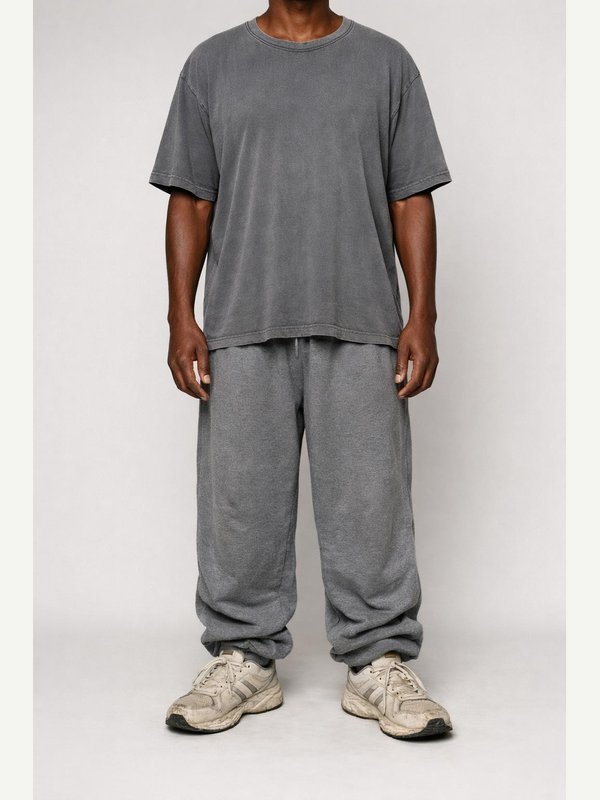 Faded oversized gray T-shirt, baggy wrinkled gray sweatpants and dirty worn white running sneakers.