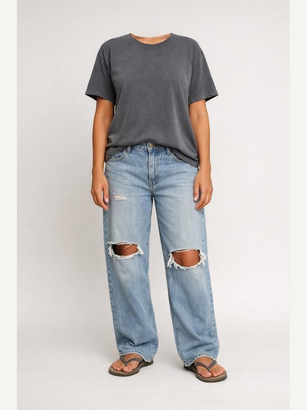 Faded loose gray slogan-free T-shirt, ripped baggy light blue jeans and worn rubber flip-flops.